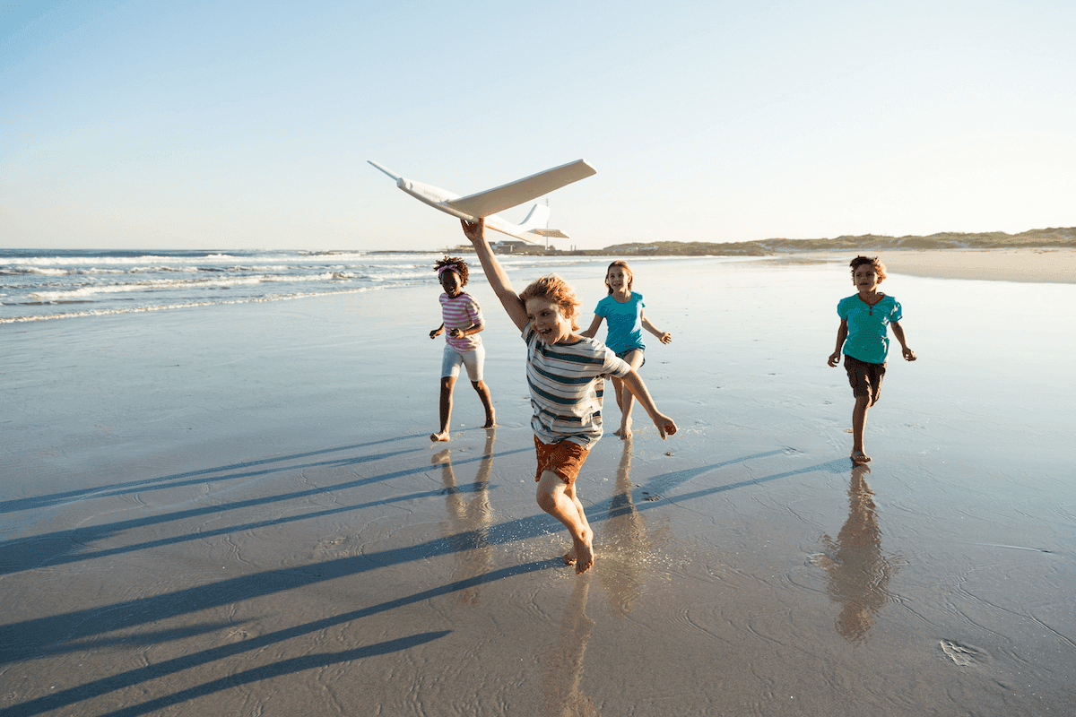 The Return Journey - Young people running with plane