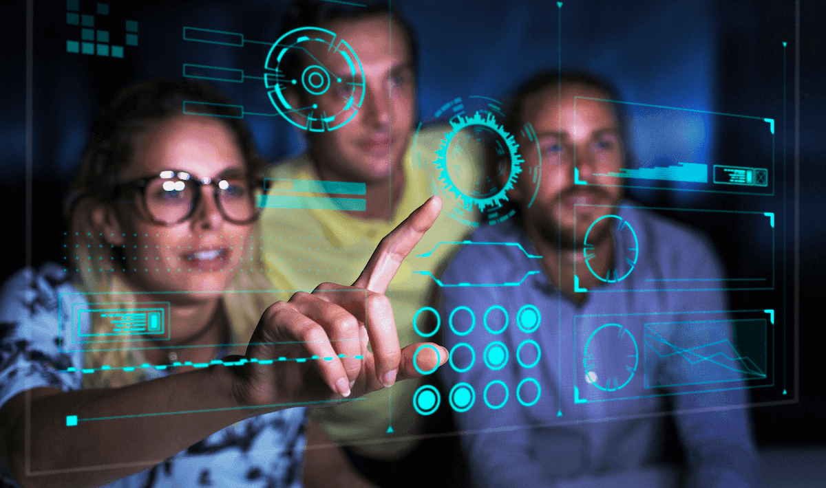 Computer programmers examining data on futuristic screen_CaiaImage_GettyImages-956550414 (1)